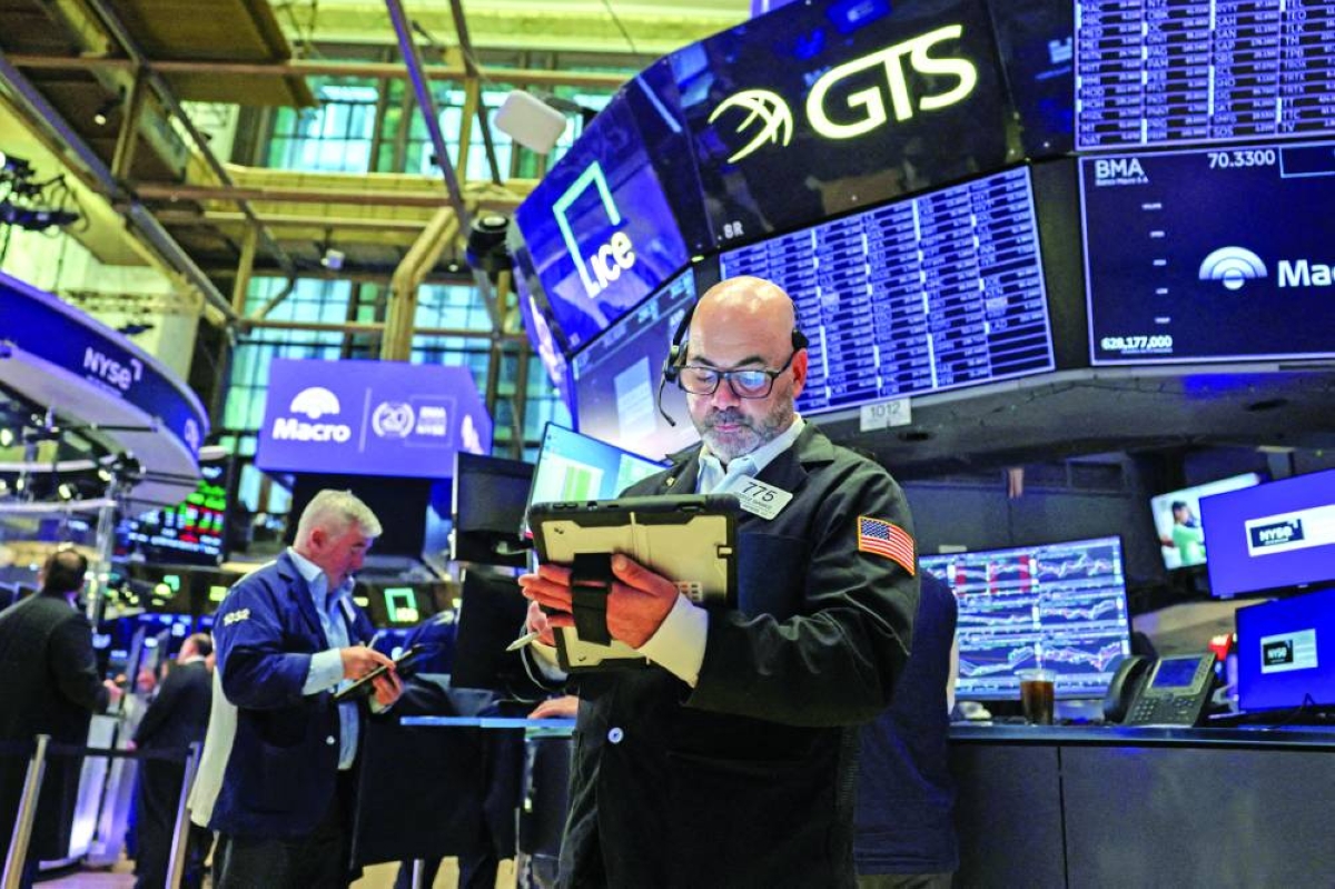 FILE PHOTO: Traders work on the floor at the New York Stock Exchange. Next week's US employment report headlines a fresh batch of economic data for stock investors, who also will closely follow developments in an Iran war that is entering its second ‌month. 