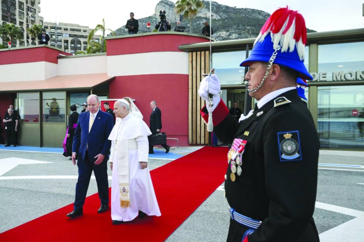 Albert II of Monaco (left) escorting Pope Leo XIV to his helicopter upon departure from Monaco Heliport in Monte Carlo, Monaco, Saturday. (AFP)