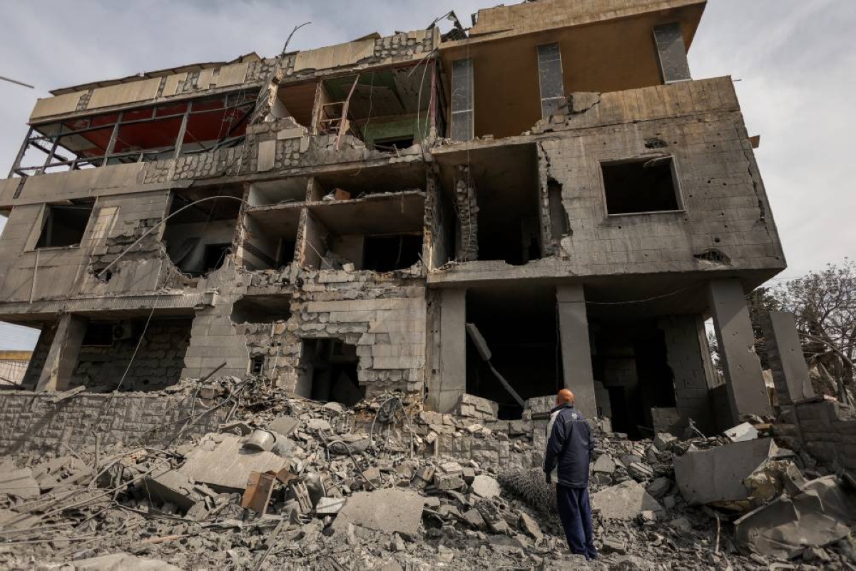 Hassan Badran, a local, looks at a house destroyed by an Israeli strike, amid escalating hostilities between Israel and Hezbollah, as the U.S.-Israeli conflict with Iran continues, in Saksakiyeh, southern Lebanon, March 28, 2026. REUTERS/Yara Nardi TPX IMAGES OF THE DAY 