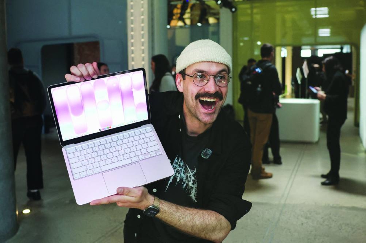 A man holds the newly-released MacBook Neo during the 'Special Apple Experience' launch event at the Apple Store in the Manhattan borough of New York City, on March 4. Apple celebrates its 50th anniversary as artificial intelligence challenges the Silicon Valley legend to prove it can deliver yet another culture-changing innovation. 