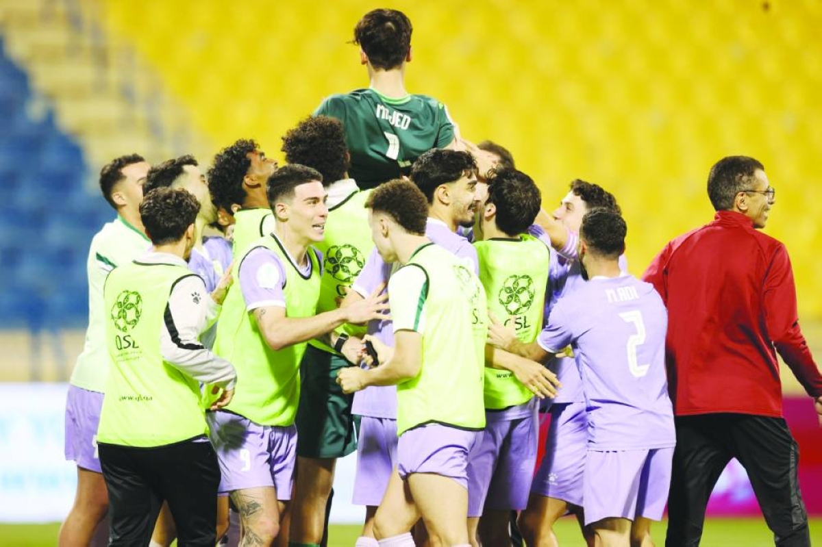 Muaither players celebrate with goalkeeper Majed Abdullatif after they beat Al Arabi 3-2 on penalties to make the QSL Cup final at the Thani Bin Jassim Stadium on Sunday.