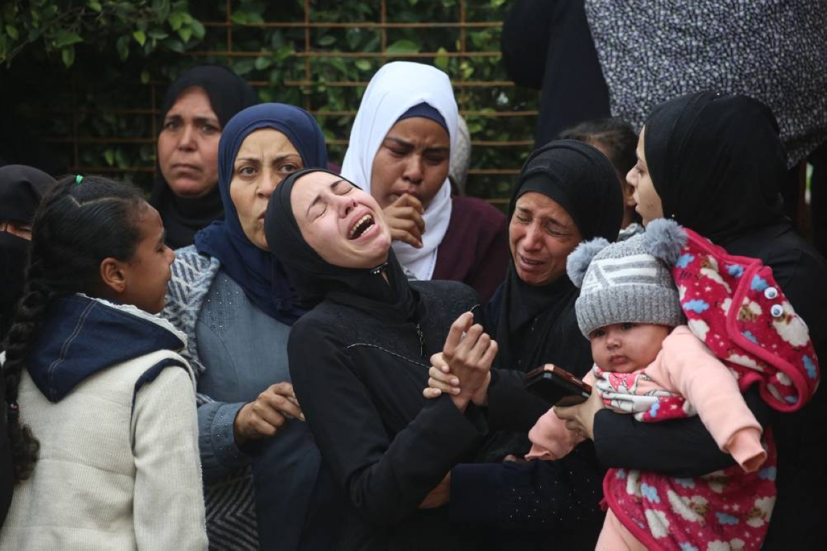 Relatives mourn the death of a loved one who was reportedly killed in an overnight Israeli strike, during the funeral of several victims at Nasser Hospital in Khan Yunis in the southern Gaza Strip, yesterday. (AFP)