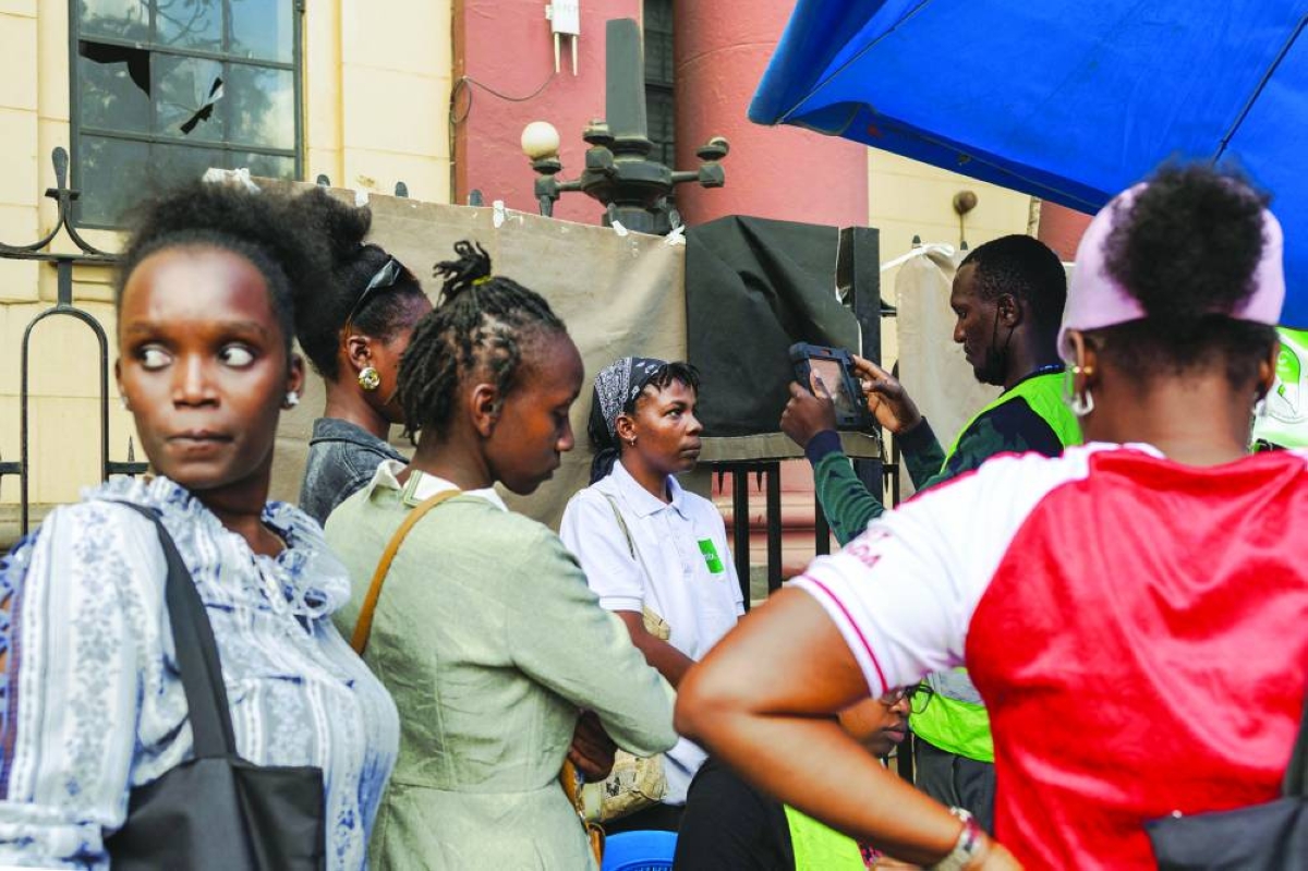 A young woman has her biometrics captured in a makeshift setup by officials using a biometric voter registrations kit (BVR) at a pop-up registration centre for new voters during a mass voter registration drive by the national election regulator, Independent Electoral Boundaries Commission (IEBC) in the Kenyan capital Nairobi, Monday.(AFP)