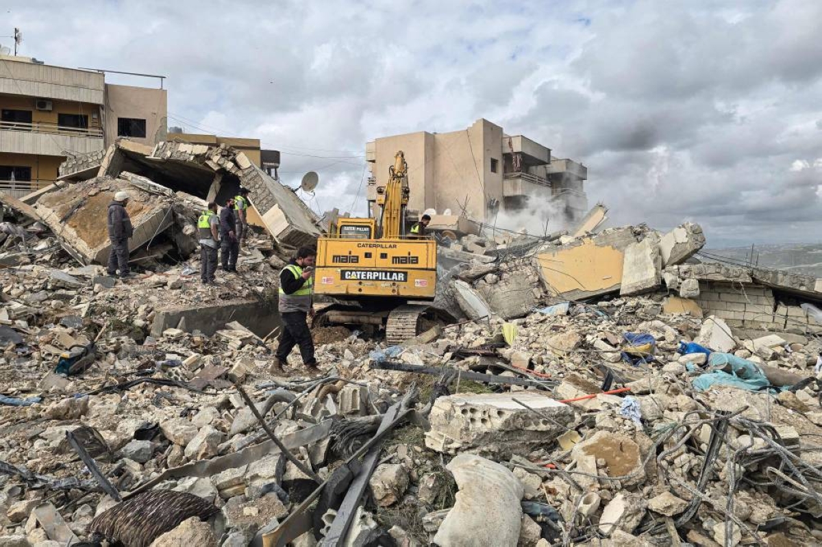 First responders work on the rubble of a building targeted by an Israeli airstrike in the southern Lebanese village of Hanouiyeh, east of Tyre, yesterday. (AFP)