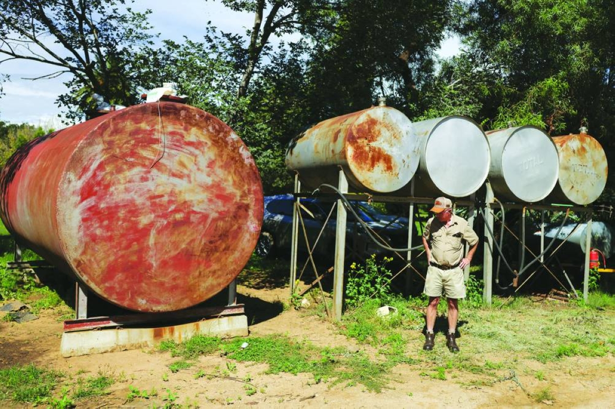 South African farmer Derek Mathews looks on as he stands next to fuel storage tanks, used for operations on his 1,700 hectare farm, amid concerns about securing supplies and affording rising fuel prices ahead of the harvest, near Lichtenburg, in the North West province. (Reuters)