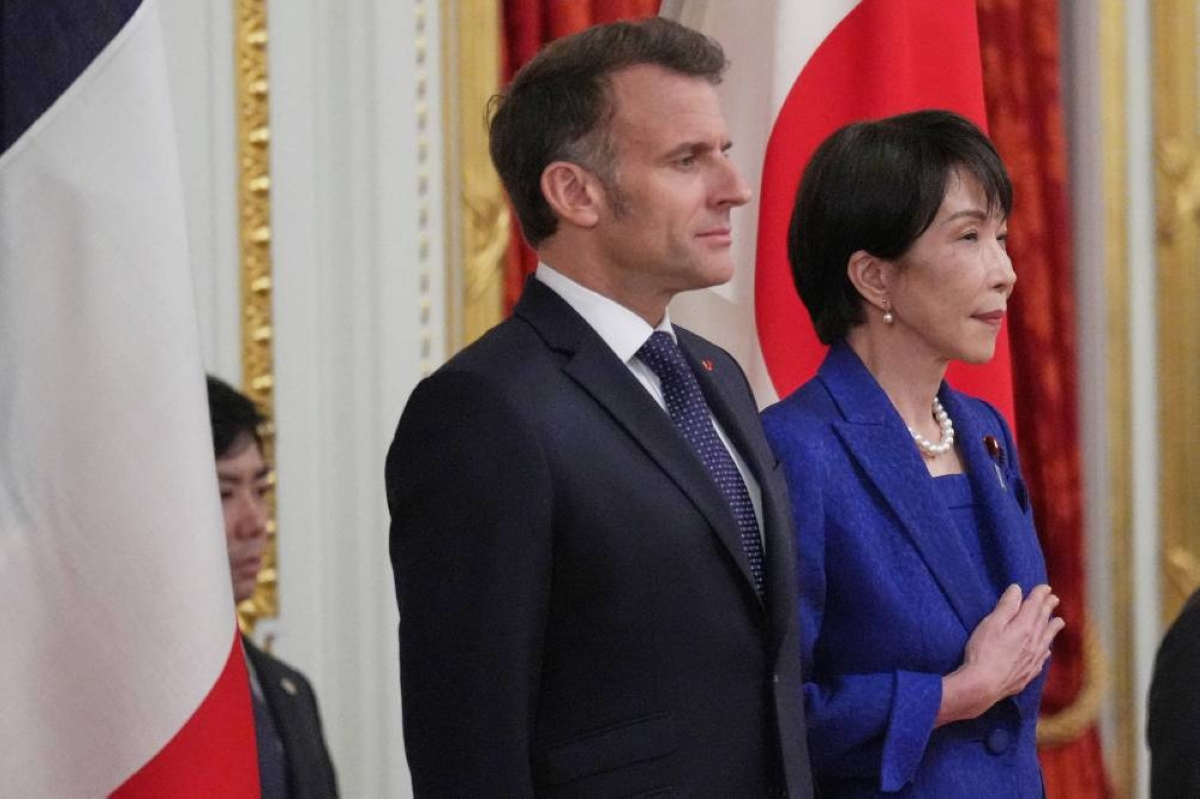 Japan’s Prime Minister Sanae Takaichi and French President Emmanuel Macron attend a welcome ceremony at the Akasaka Palace State Guest House in Tokyo, yesterday. (Reuters)