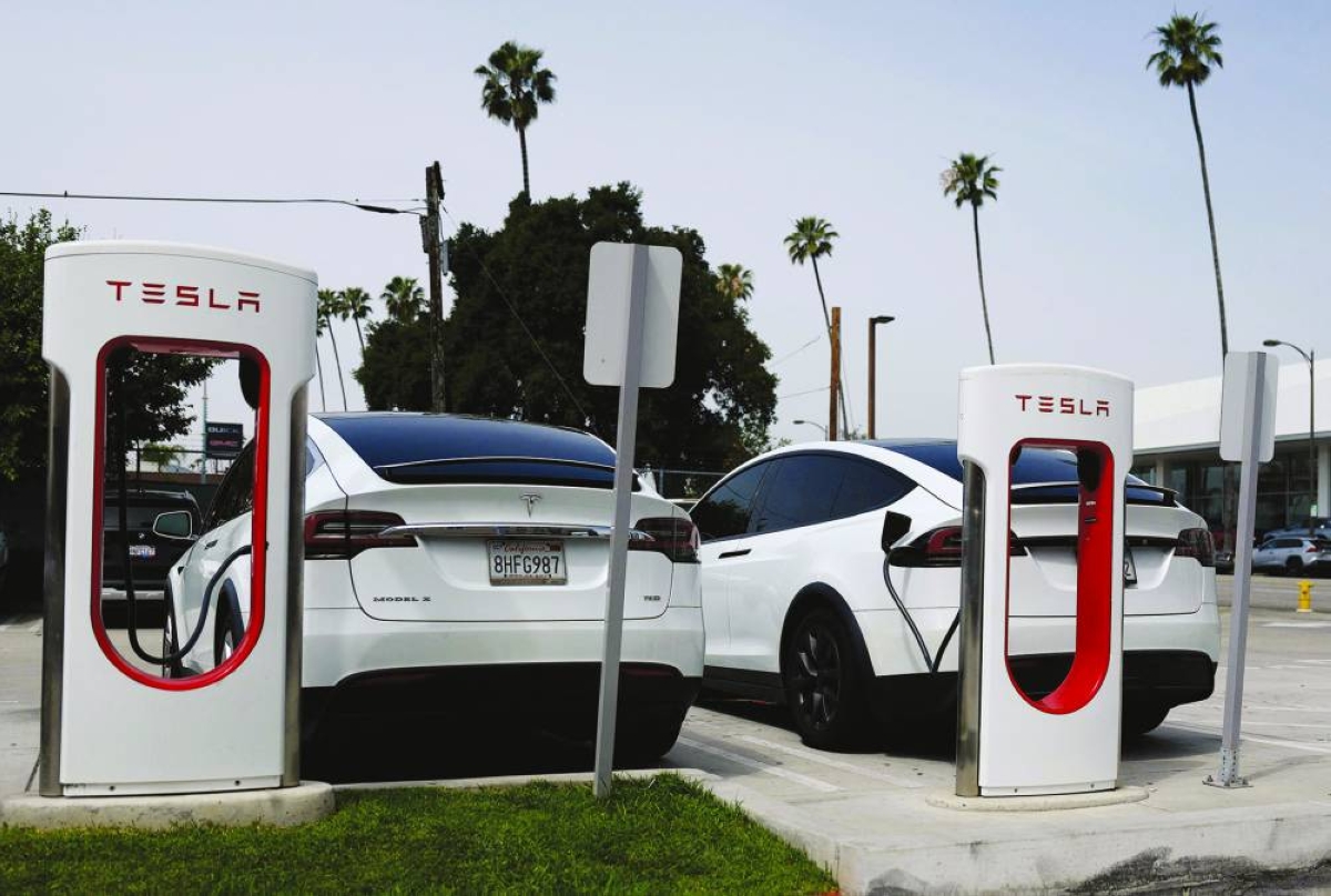 Tesla cars charge at a Tesla Supercharger station in Pasadena, California. Slower sales are likely the new normal for Tesla as it increasingly pivots its focus to AI, autonomy and robotics amid weakening global EV demand, and a US market that now lacks a federal tax incentive for plug-in cars.