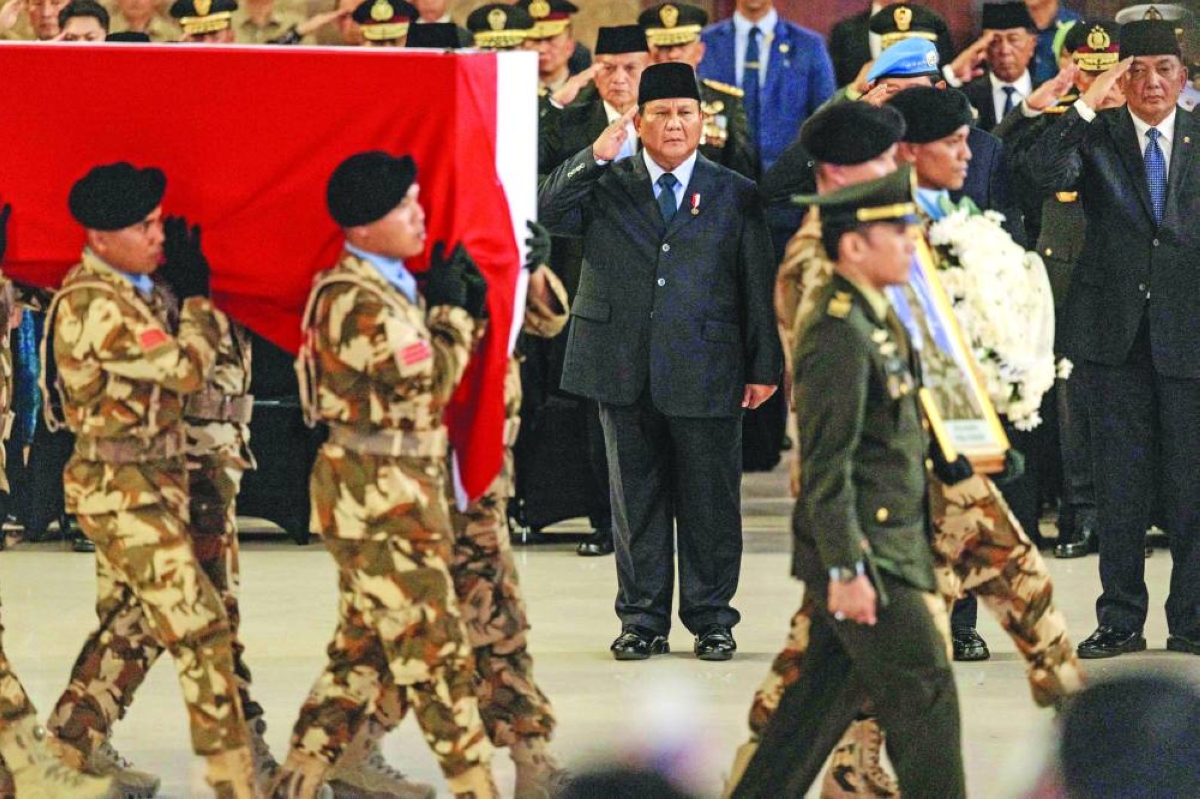 Indonesian President Prabowo Subianto (centre) salutes the coffins of Indonesian soldiers killed while serving with the United Nations Interim Force in Lebanon as they arrive at Soekarno-Hatta International Airport in Tangerang Saturday.(AFP)