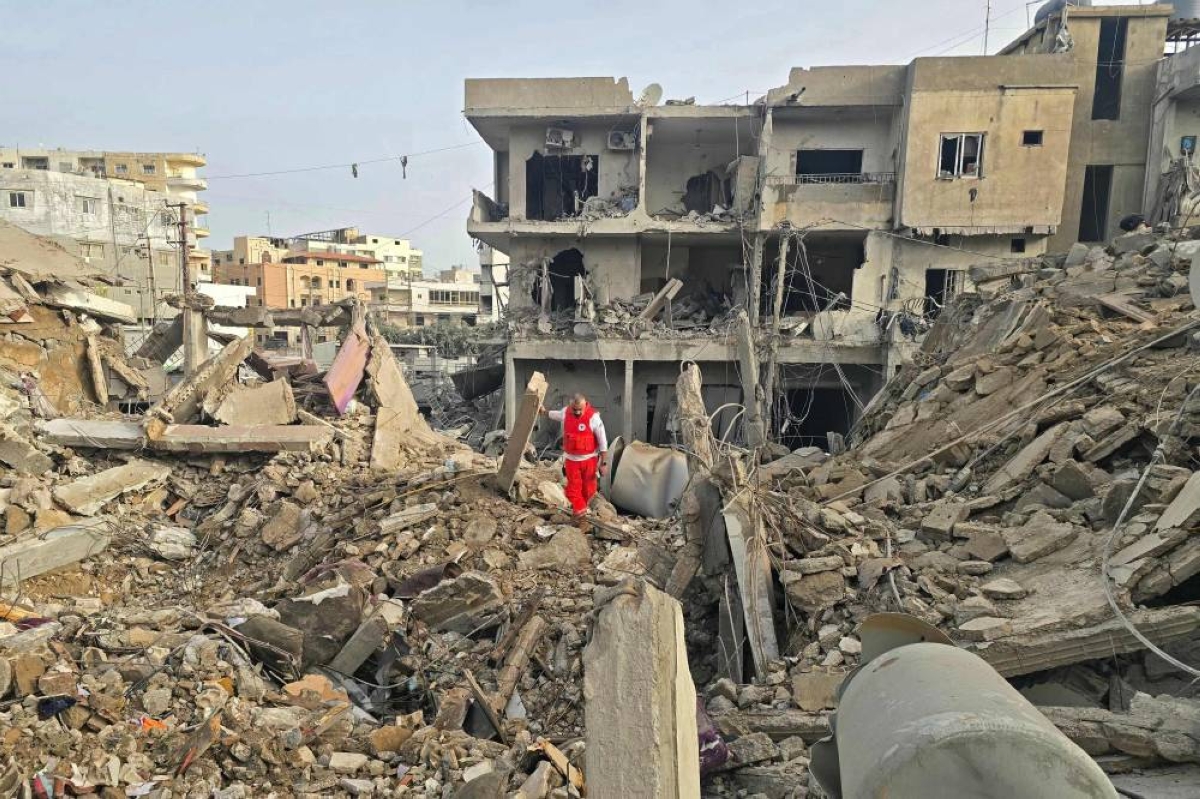 A rescue worker inspects the debris of destroyed buildings at the site of an Israeli strike in the southern Lebanese area of Maarakeh near the coastal city of Tyre, yesterday. (AFP)