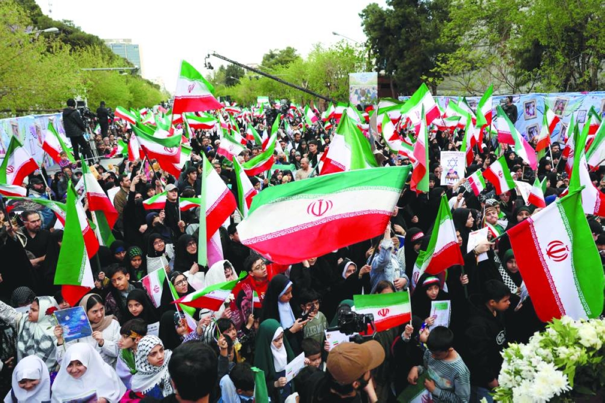 Iranians rally during a memorial, 40 days after a deadly strike on a children’s school in the southern city of Minab, in Tehran, Tuesday. (AFP)