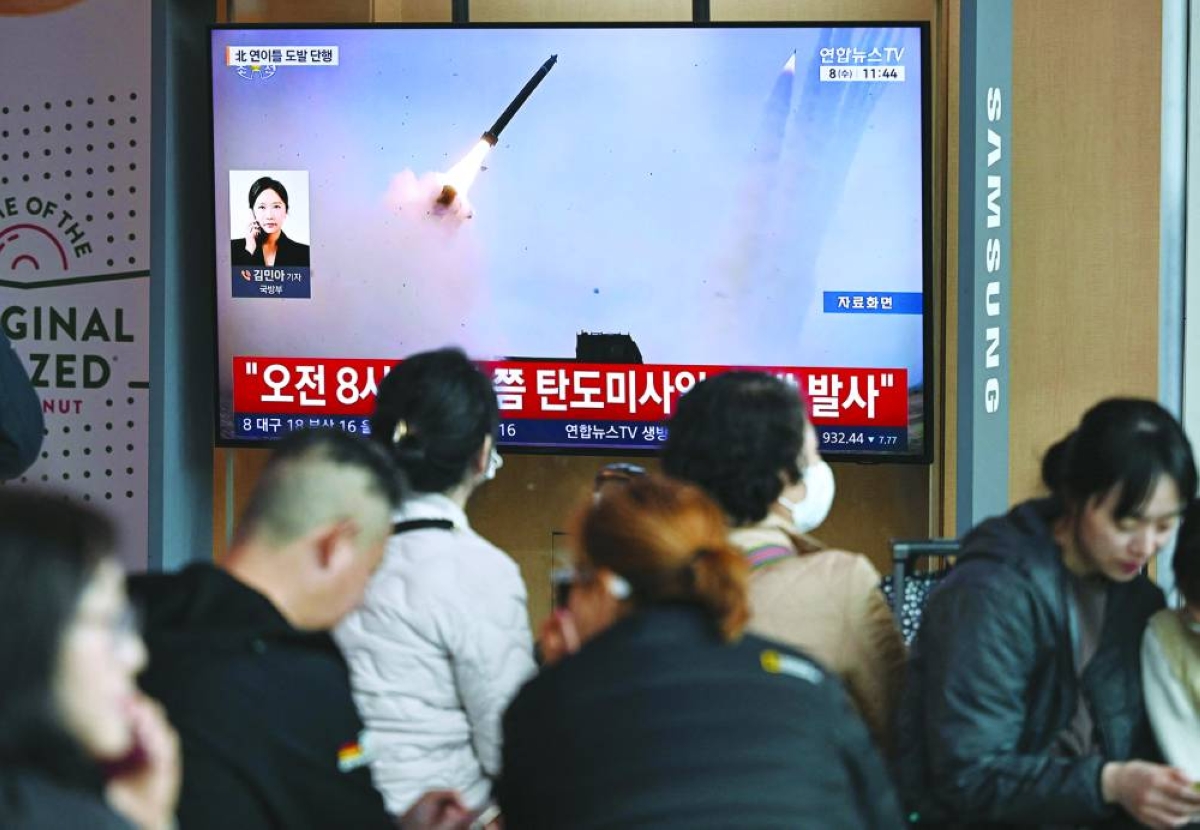 People watch a television screen showing a news broadcast with file footage of a North Korean missile test, at a train station in Seoul Wednesday. (AFP)