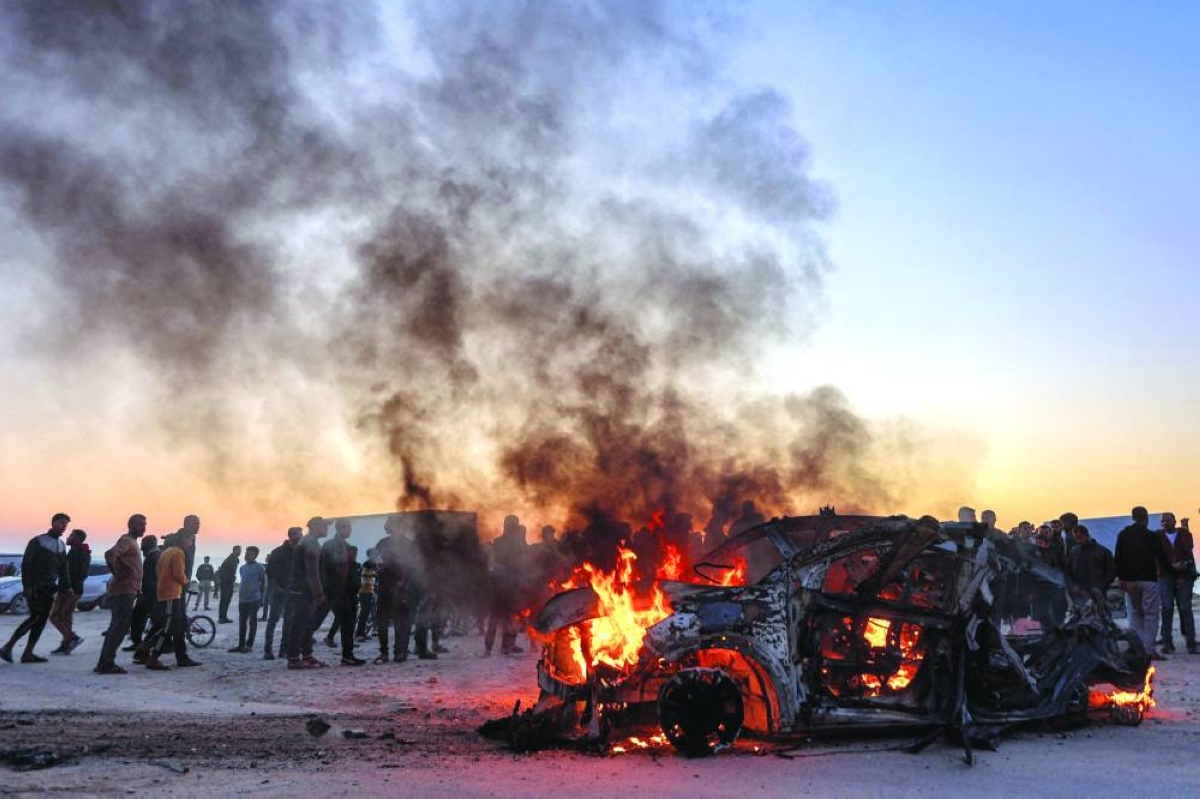 Flames rise after a strike on the vehicle of Palestinian journalist Muhammad Washah in southern Gaza City, Wednesday. (AFP)