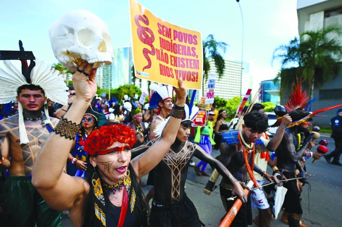 Indigenous people march to the Congress building with a sign reading "Without indigenous peoples, there are no living rivers" during the annual Indigenous gathering Acampamento Terra Livre in Brasilia on Tuesday. (AFP)
