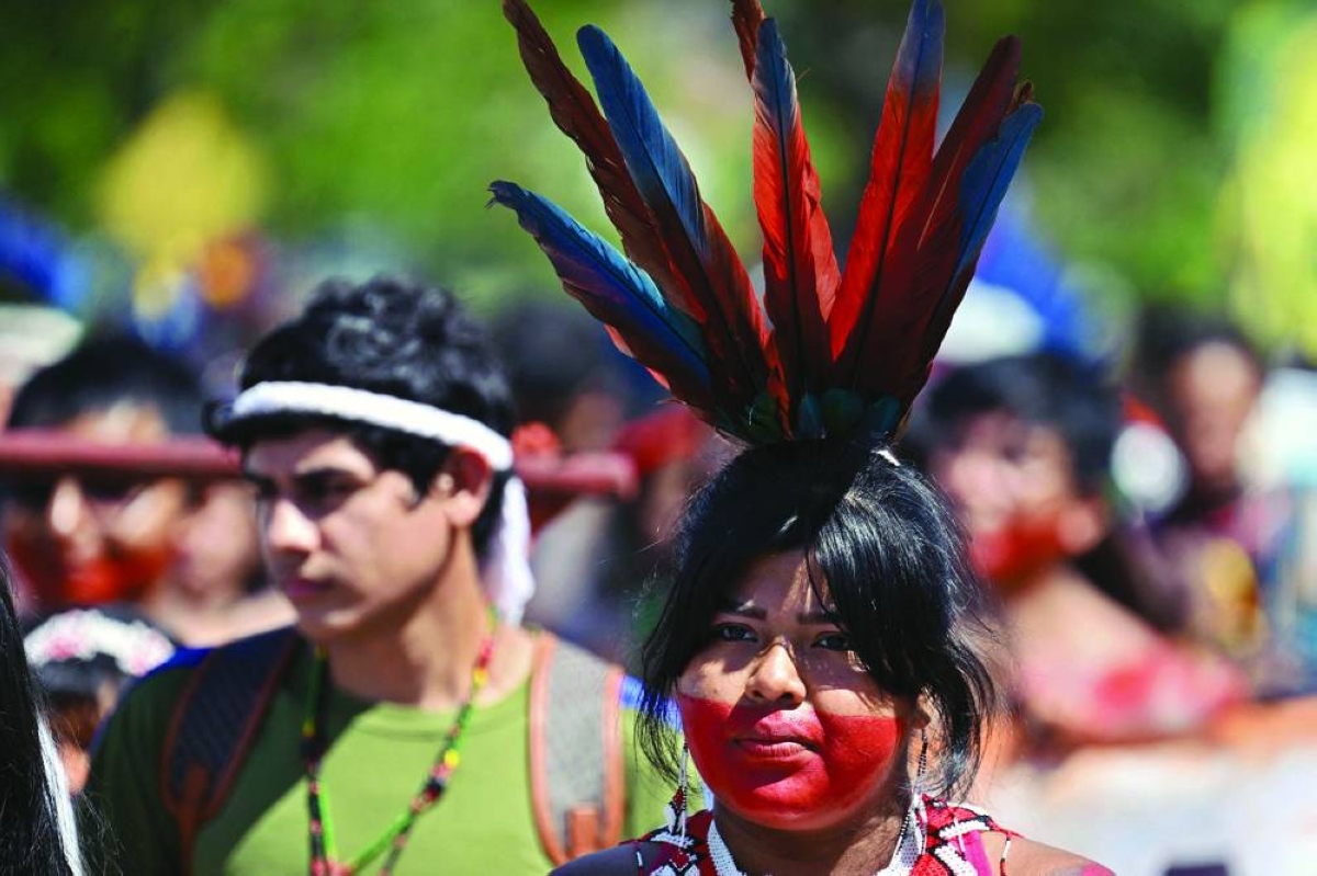 An Indigenous woman takes part in a march to the Congress building during the annual Indigenous gathering Acampamento Terra in Brasilia on Tuesday. (AFP)