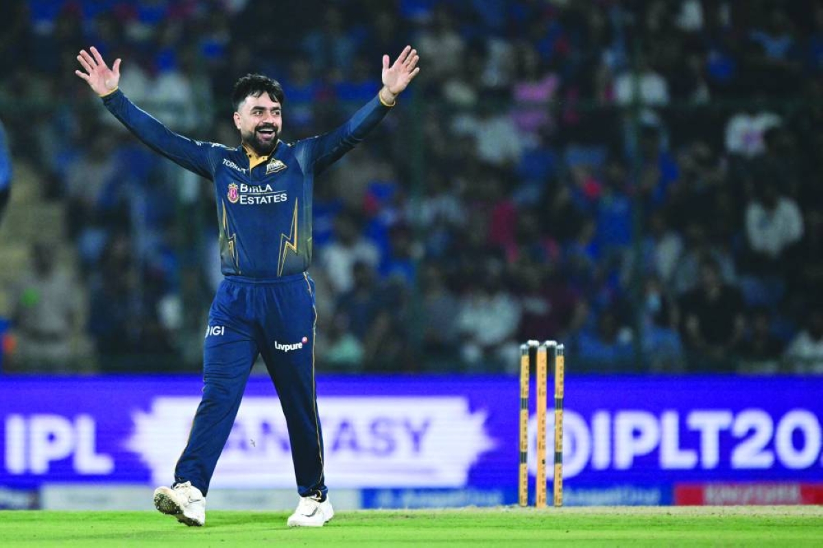 Gujarat Titans’ Rashid Khan celebrates after taking the wicket of Delhi Capitals’ captain India’s Axar Patel during the IPL match in New Delhi Wednesday. (AFP)