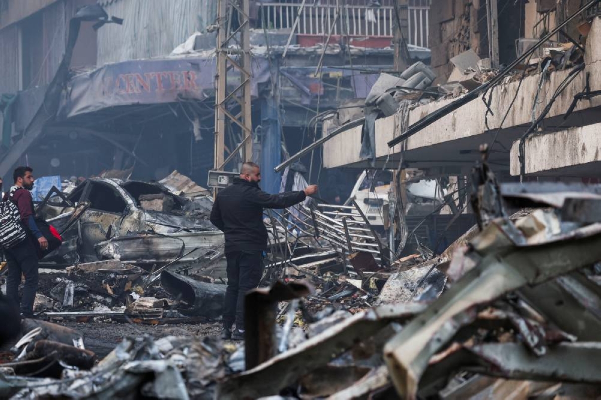 People stand at the site of an Israeli strike, in Al-Mazraa in Beirut, Lebanon, April 8, 2026. REUTERS/Yara Nardi