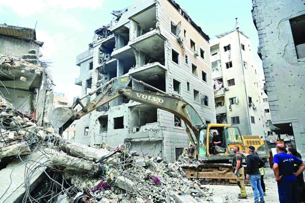 
This photograph taken yesterday, during a media tour organised by Hezbollah’s media office shows a digger clearing the rubble of a building in Beirut’s Hay al-Selloum neighbourhood, that was targeted in an Israeli strike earlier this week. (AFP) 