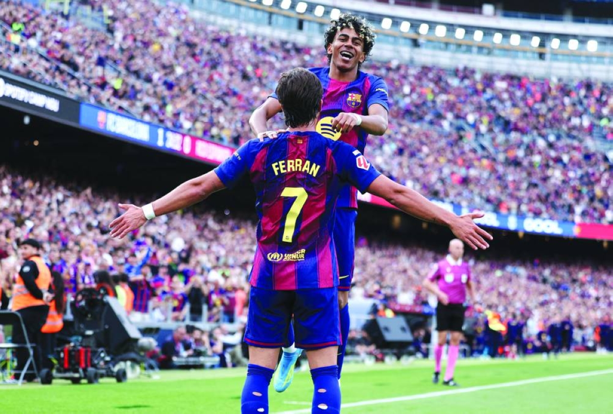 Barcelona’s Ferran Torres celebrates with Lamine Yamal scoring his team’s second goal during the La LIga match against Espanyol at the Camp Nou stadium in Barcelona Saturday. (AFP)