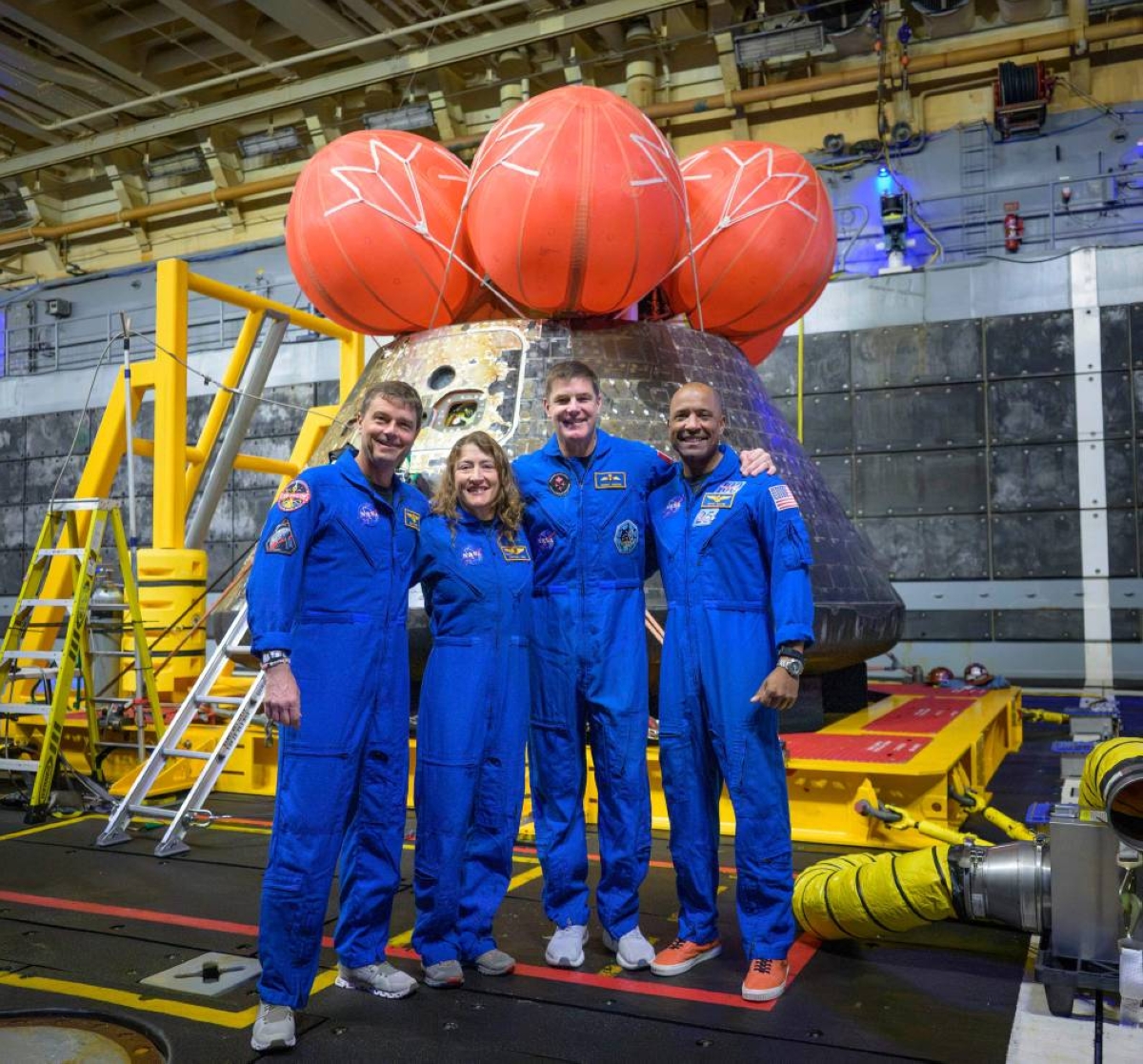 From left: Nasa astronauts Reid Wiseman, commander, Christina Koch, mission specialist, Canadian Space Agency astronaut Jeremy Hansen, mission specialist, and Nasa astronaut Victor Glover, Artemis II pilot, posing for a group photo after viewing the Orion spacecraft in the well deck of USS John P. Murtha, yesterday, in the Pacific Ocean off the coast of California. (AFP)