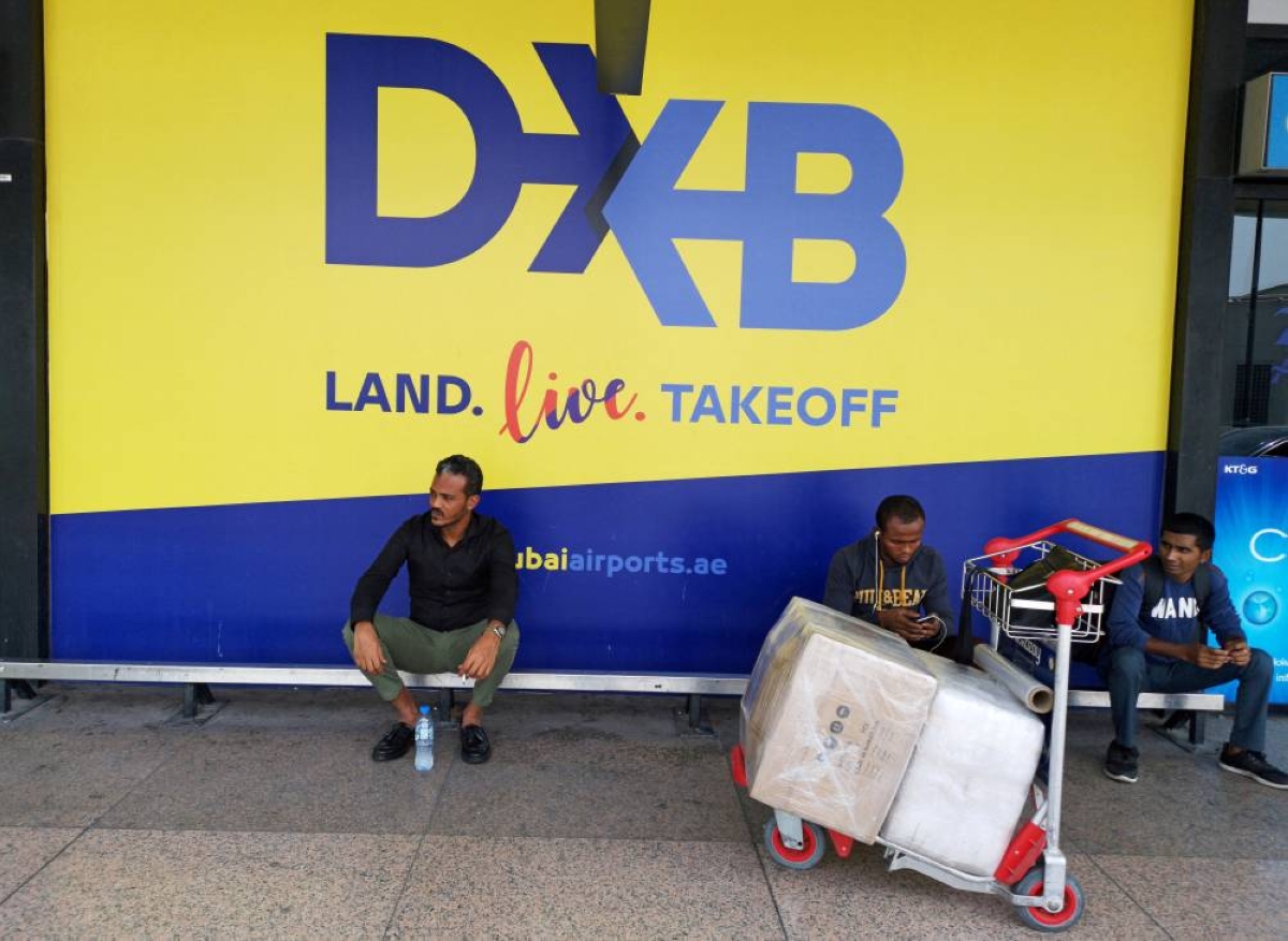 Passengers sit next to a logo of Dubai Airport, at the departure hall of terminal one, Dubai, United Arab Emirates. (Reuters/File Photo)