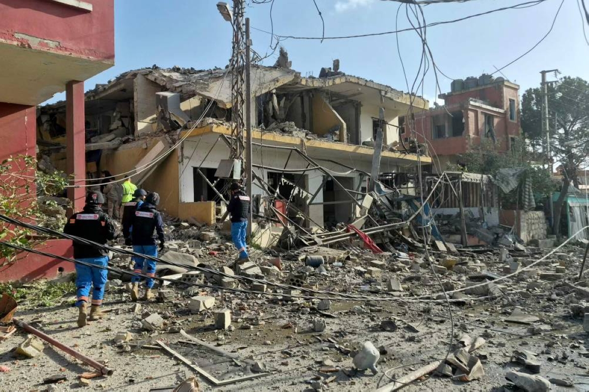 First responders gather at the site of an Israeli airstrike that targeted a neighbourhood in the southern Lebanese village of Kfar Roummane, yesterday. (AFP)