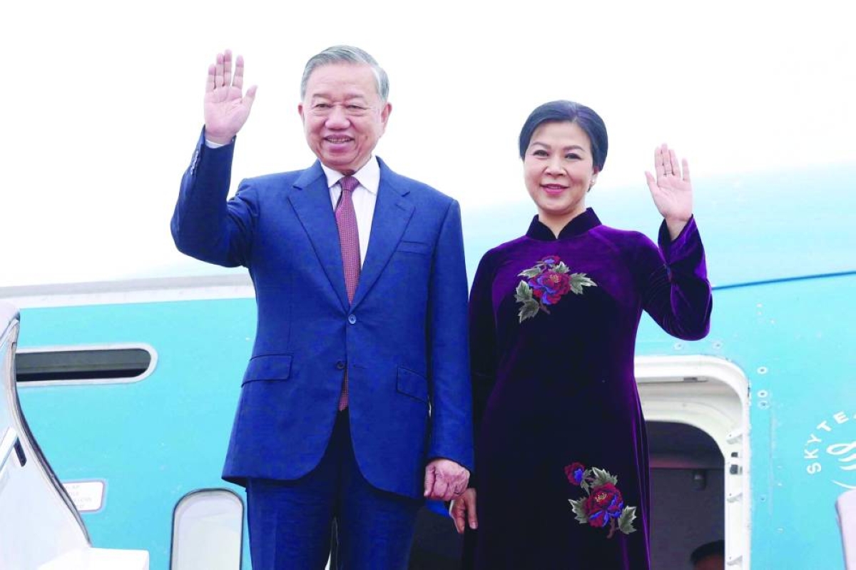 
To Lam and his wife Ngo Phuong Ly waving upon their arrival at Beijing International Airport. (AFP) 