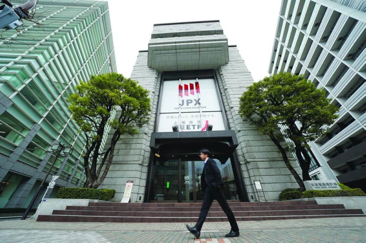 A pedestrian walks past the Tokyo Stock Exchange building. The Nikkei 225 closed up 0.4% to 58,134.24 points Wednesday.