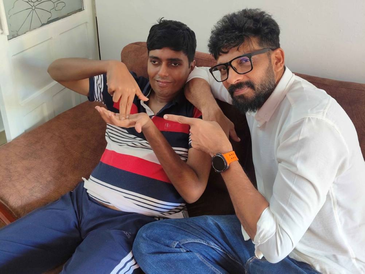 Imthiyas Aboobacker with his cousin Sameer, who inspired him to start the finger therapy initiative.