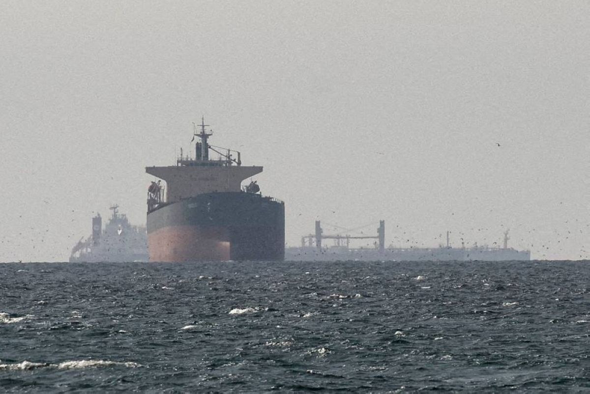 FILE PHOTO: Cargo ships in the Gulf, near the Strait of Hormuz, as seen from northern Ras al-Khaimah, near the border with Oman’s Musandam governance, amid the U.S.-Israeli conflict with Iran, in United Arab Emirates, March 11, 2026. REUTERS/Stringer/File Photo