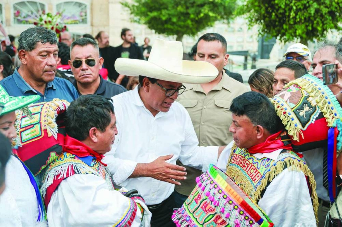 Peru's presidential candidate for the Juntos por el Peru party, Roberto Sanchez, greets supporters in Lima on Wednesday. (AFP)