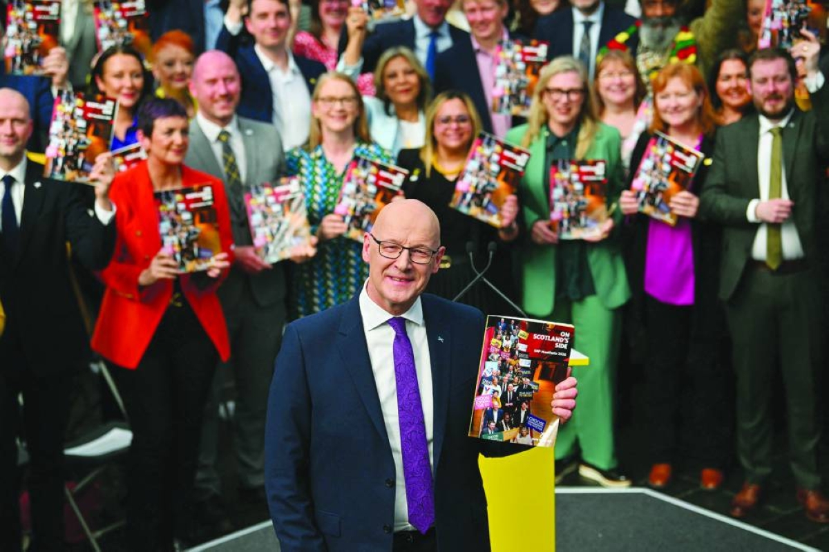 Scotland's First Minister and Scottish National Party (SNP) leader John Swinney poses for a photo as he takes part in the launch the SNP's 2026 Scottish Parliament election manifesto in Glasgow Thursday. (AFP)