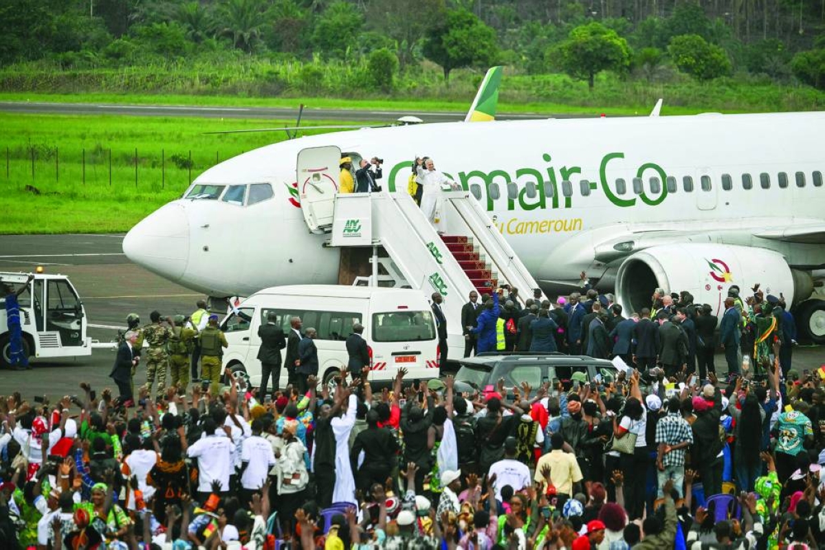 Pope Leo XIV waves to his supporters as he boards a plane after leading the Holy Mass at Bamenda Airport, on the fourth day of an 11-day apostolic journey to Africa. – AFP