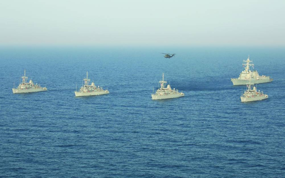 
A formation of Avenger-class mine countermeasure ships and an MH-53E Sea Dragon helicopter assigned to the “Blackhawks” of Helicopter Mine Countermeasures Squadron (HSM) 15 in the Arabian Sea. (Reuters/File Photos) 