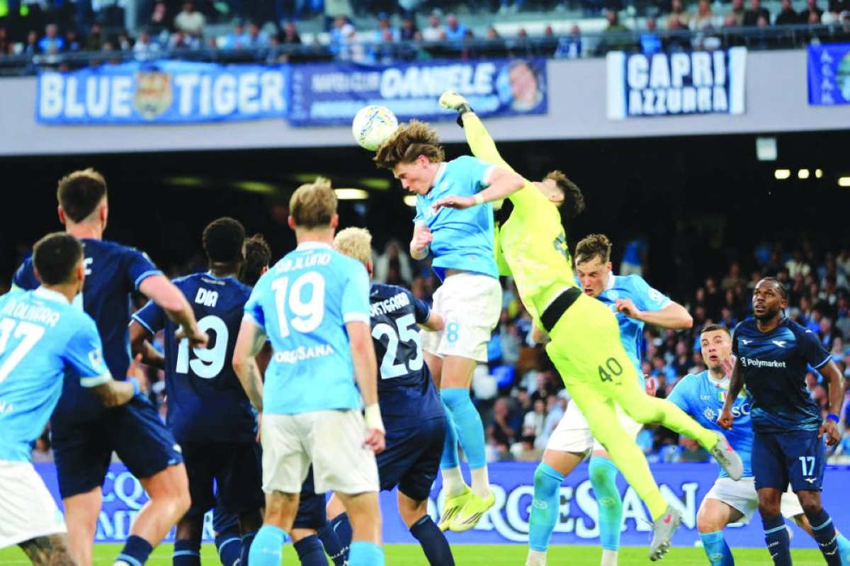 Lazio's goalkeeper #40 Edoardo Motta makes a save in front of Napoli's Scottish midfielder #08 Scott McTominay during the Italian Serie A football match between Napoli and Lazio at the Diego Armando Maradona stadium in Naples on April 18, 2026. (AFP)
