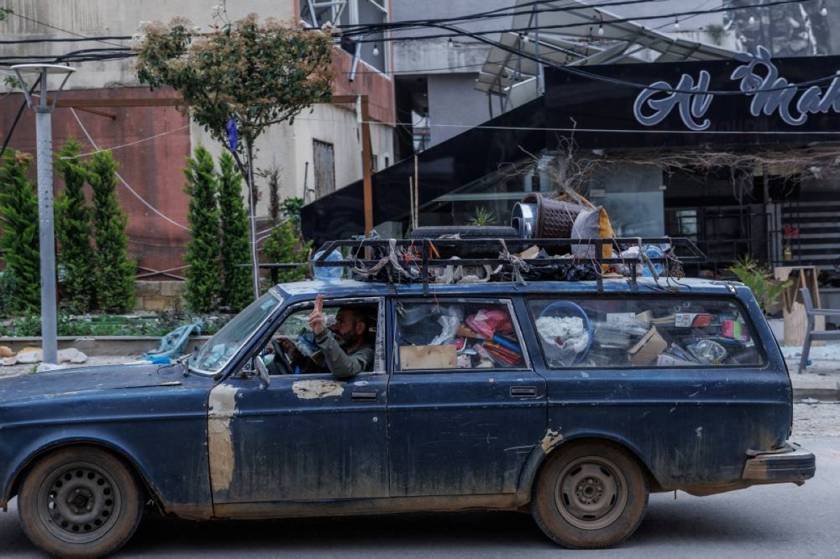 A man drives as he flashes a victory sign following a 10-day ceasefire between Lebanon and Israel went into effect, in Nabatieh, Lebanon, April 18, 2026. REUTERS/Zohra Bensemra