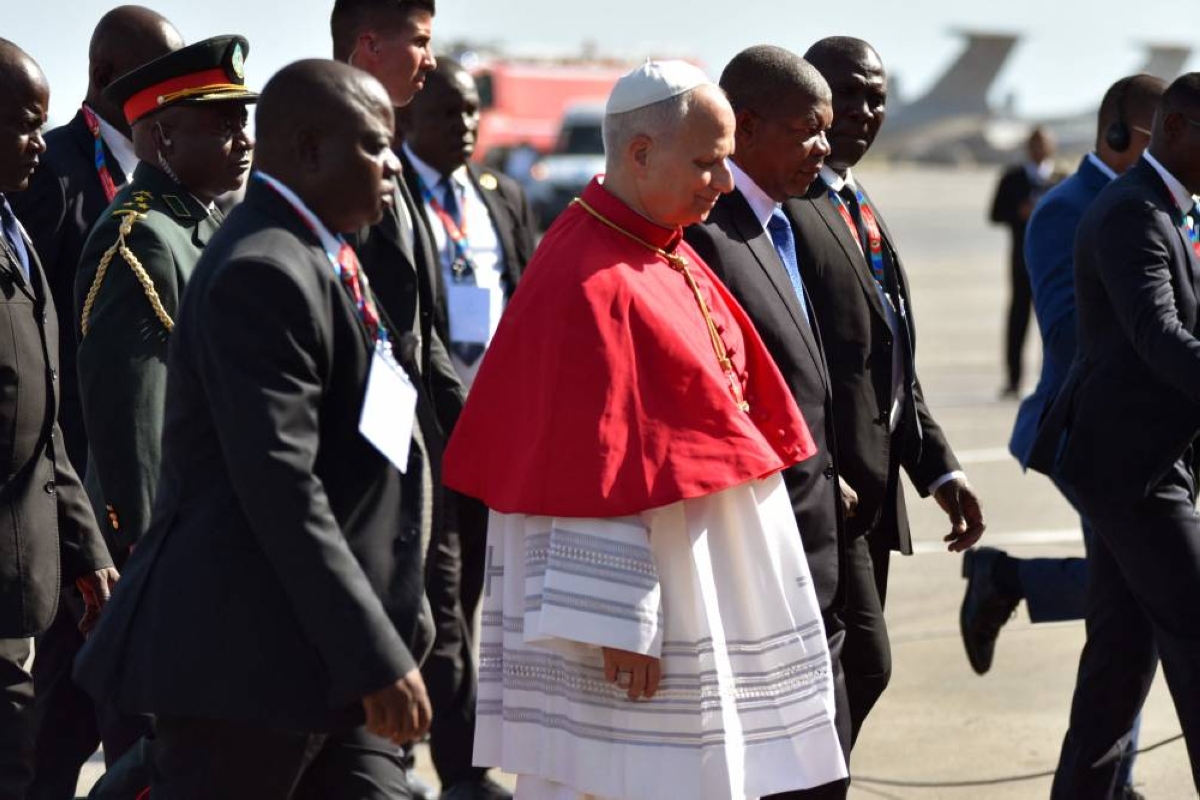 Pope Leo XIV (CL) is welcomed by Angola's President Joao Lourenco (CR) upon his arrival at the "4 de Fevereiro" Luanda International Airport in Luanda on the sixth day of an 11-day apostolic journey to Africa, on April 18, 2026. (Photo by Julio PACHECO NTELA / AFP)