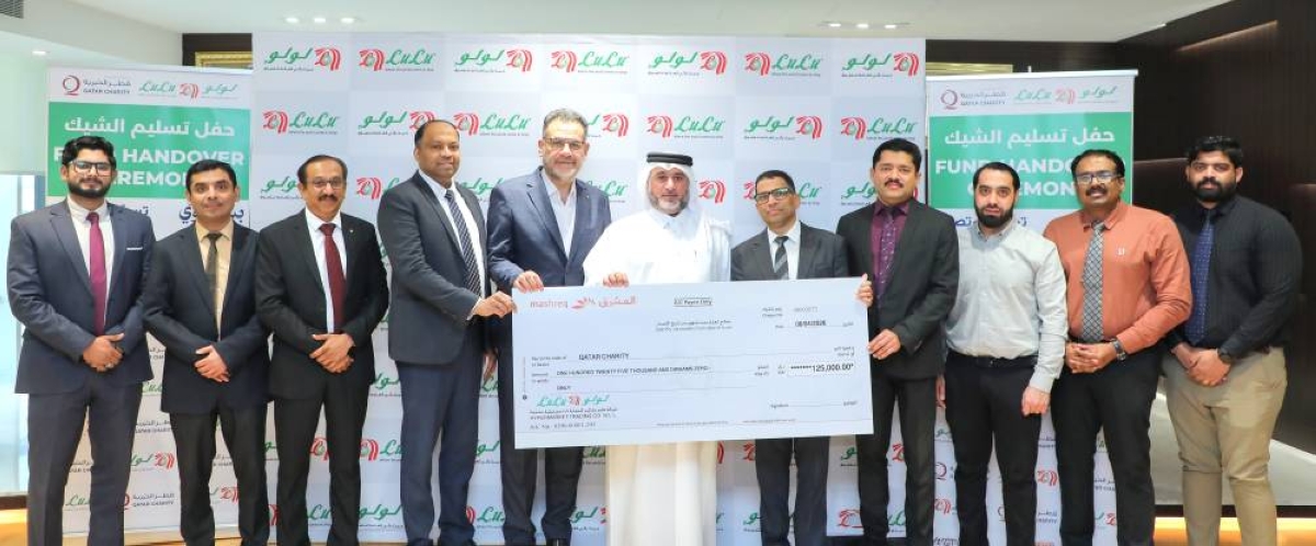 Shanavas P M, regional director of LuLu Hypermarket Qatar, presenting the cheque to Amer Mohammed al-Besiri, deputy director of Donor Relations at Qatar Charity.  