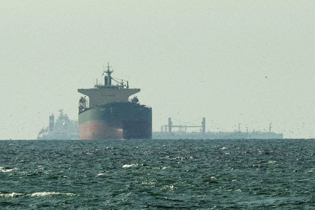 Cargo ships in the Gulf, near the Strait of Hormuz, as seen from northern Ras al-Khaimah, near the border with Oman’s Musandam governance, amid the US-Israeli conflict with Iran. The world’s top oil traders warned that the ongoing closure of the Strait of Hormuz is increasing the risk of a global recession as fuel-demand takes a hit.