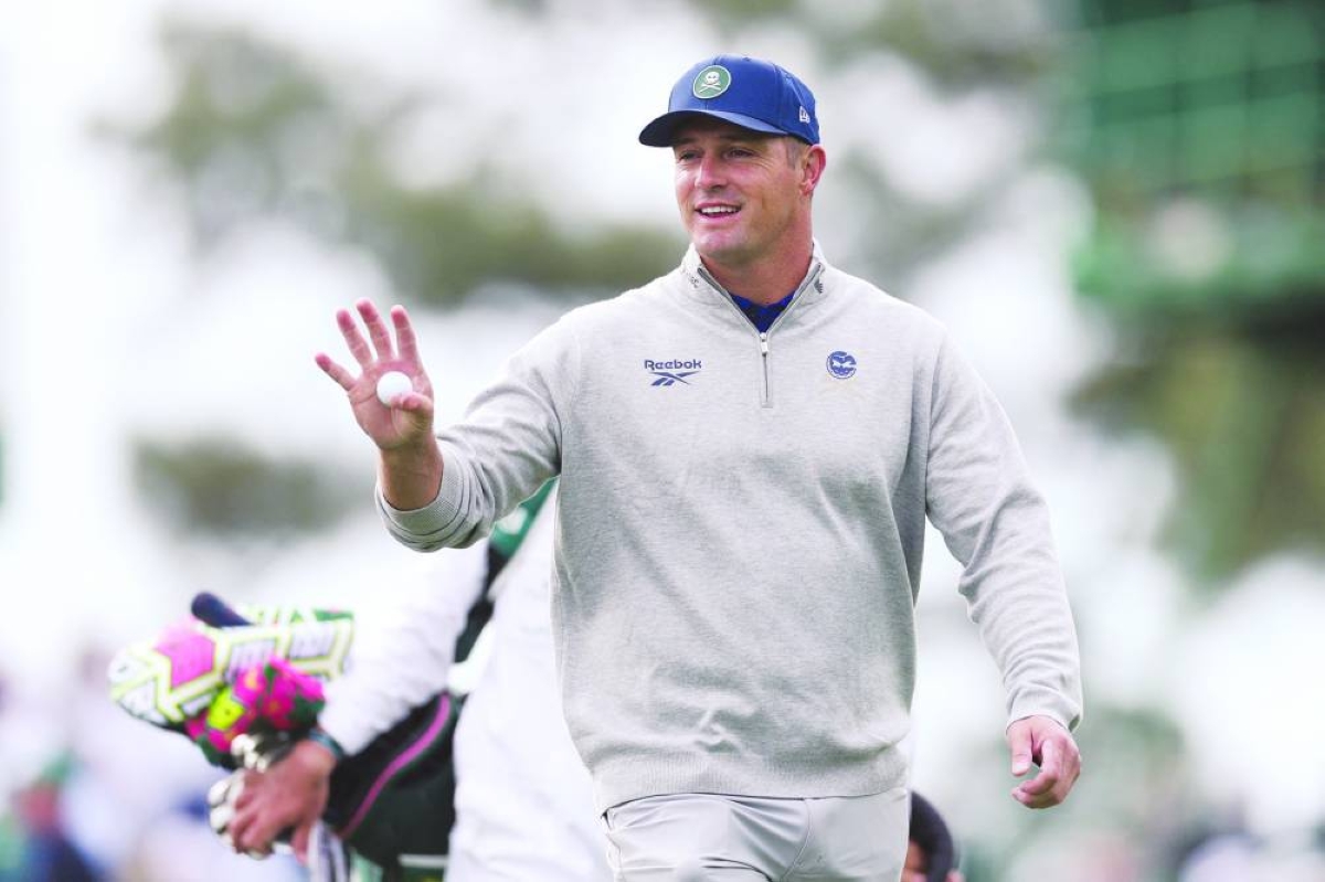 Bryson DeChambeau of the United States acknowledges a gallery of patrons while playing the third hole during a practice round prior to the 2026 Masters Tournament at Augusta National Golf Club on April 07, 2026 in Augusta, Georgia. (AFP)