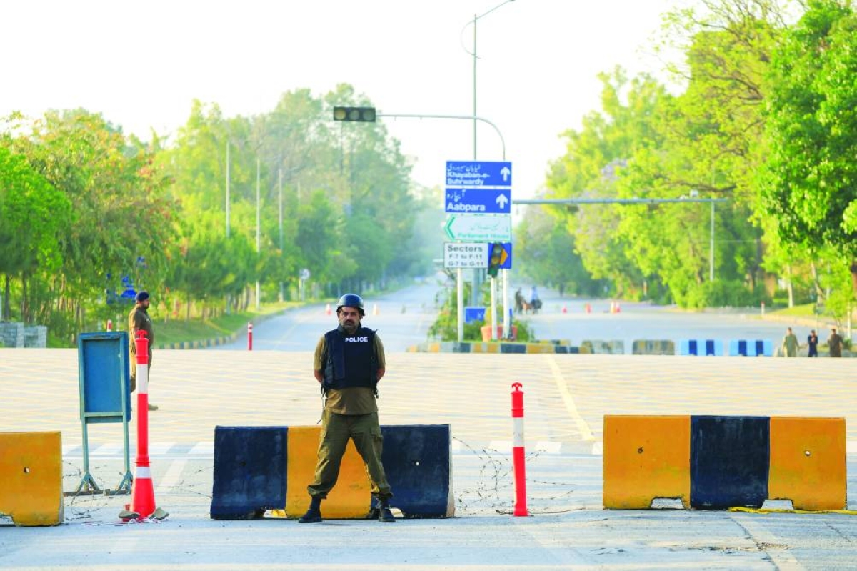 Police officers stand guard on a road leading to the Serena Hotel Tuesday as Pakistan prepared to host the US and Iran for the second phase of peace talks in Islamabad. (Reuters)