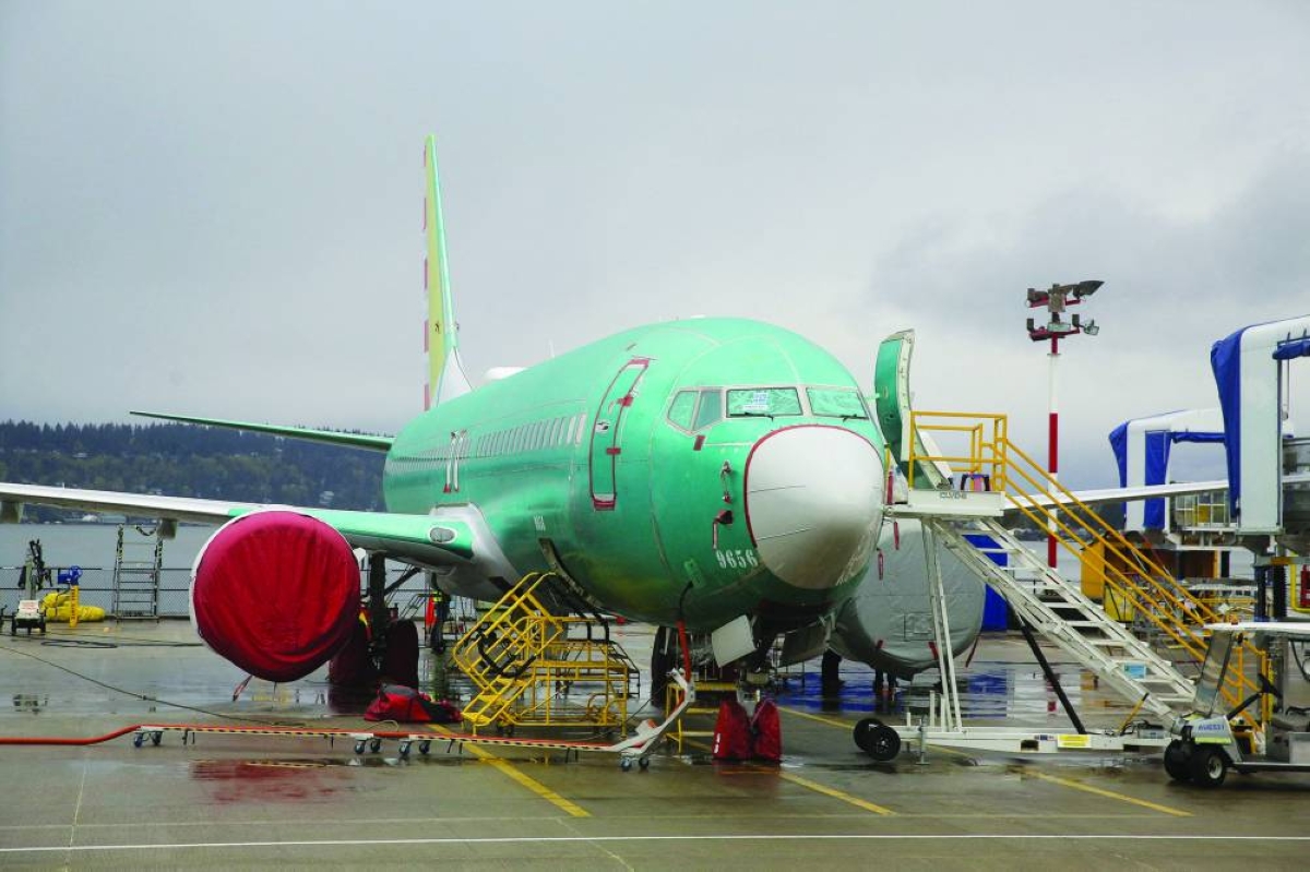 A Boeing 737 Max is parked outside the Renton facility in Washington. Boeing reported a small quarterly loss on Wednesday following an uptick in commercial plane deliveries as the aerospace giant pointed to progress on a turnaround after a long period of stumbles.