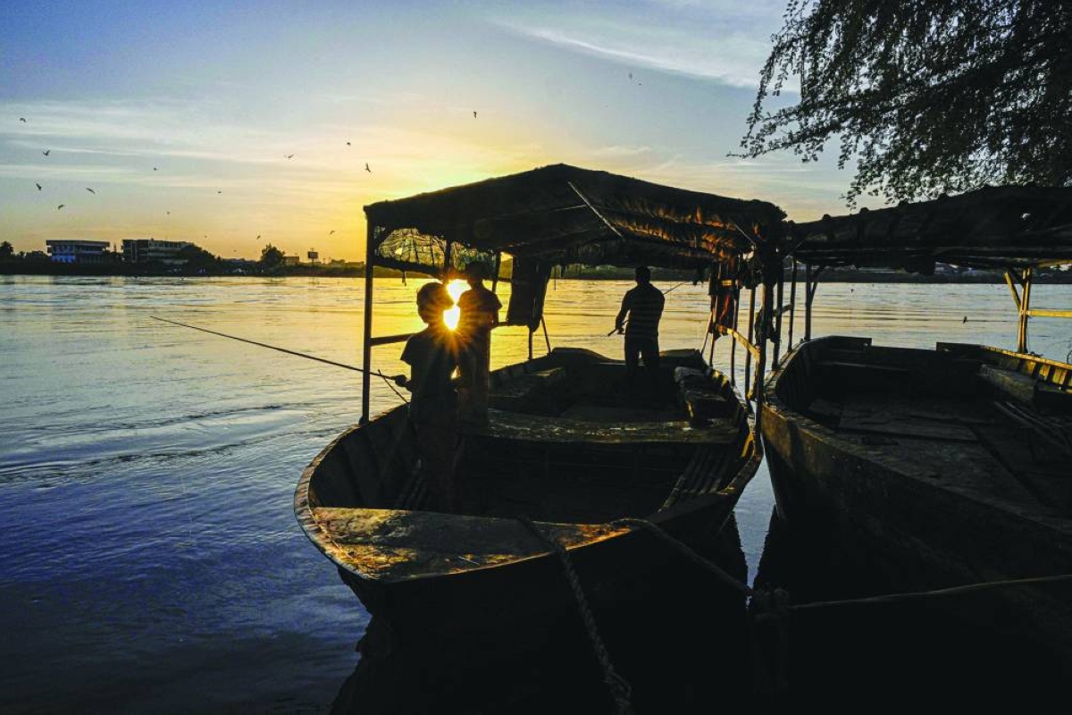 Local residents of Tuti Island, where the White Nile and Blue Nile merge to form the River Nile, stand in a small boat fishing in Khartoum on April 17, 2026. Located where the White Nile, flowing from Uganda, meets the Blue Nile from Ethiopia, Tuti is across the river from where war first broke out in April 2023, between Sudan's army and the paramilitary Rapid Support Forces. In recent months, many residents have returned home to the island, besieged from June 2023 until March 2025, when the army recaptured Sudan's capital. (AFP)