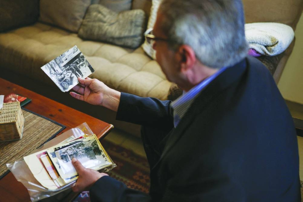 Head of the Lebanese NGO Fighters for Peace Ziad Saab looks at a picture of himself during the Lebanese civil war, in his home in Beirut, Lebanon, April 14, 2026. REUTERS