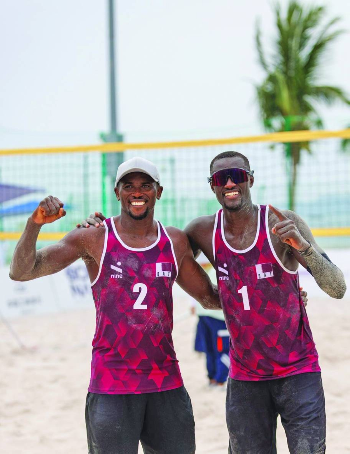 Qatar's beach volleyball pair Cherif Younousse and Ahmed Tijan celebrate after their win over Uzbekistan at the Asian Beach Games in Sanya, China.