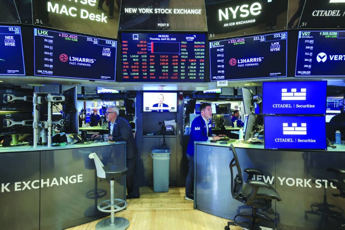 Traders work on the floor at the New York Stock Exchange. A scorching US stock rally faces a test from a mammoth week of corporate results led by ‌major technology companies, along with a Federal Reserve meeting that could mark the end of Jerome Powell's tenure ​as head of the US central bank.
