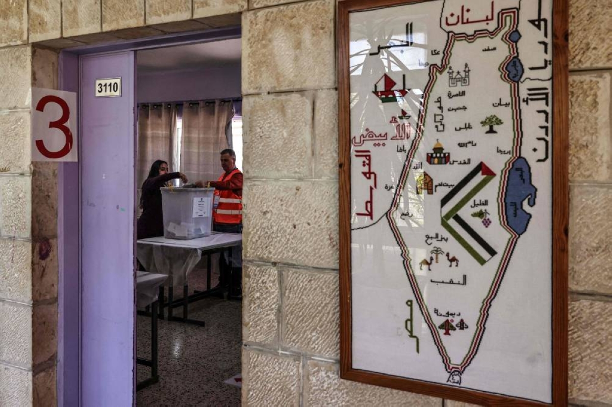 A woman casts her ballot at a polling station during municipal elections in Palestinian town of Birzeit, north of Ramallah in the Israeli-occupied West Bank. – AFP