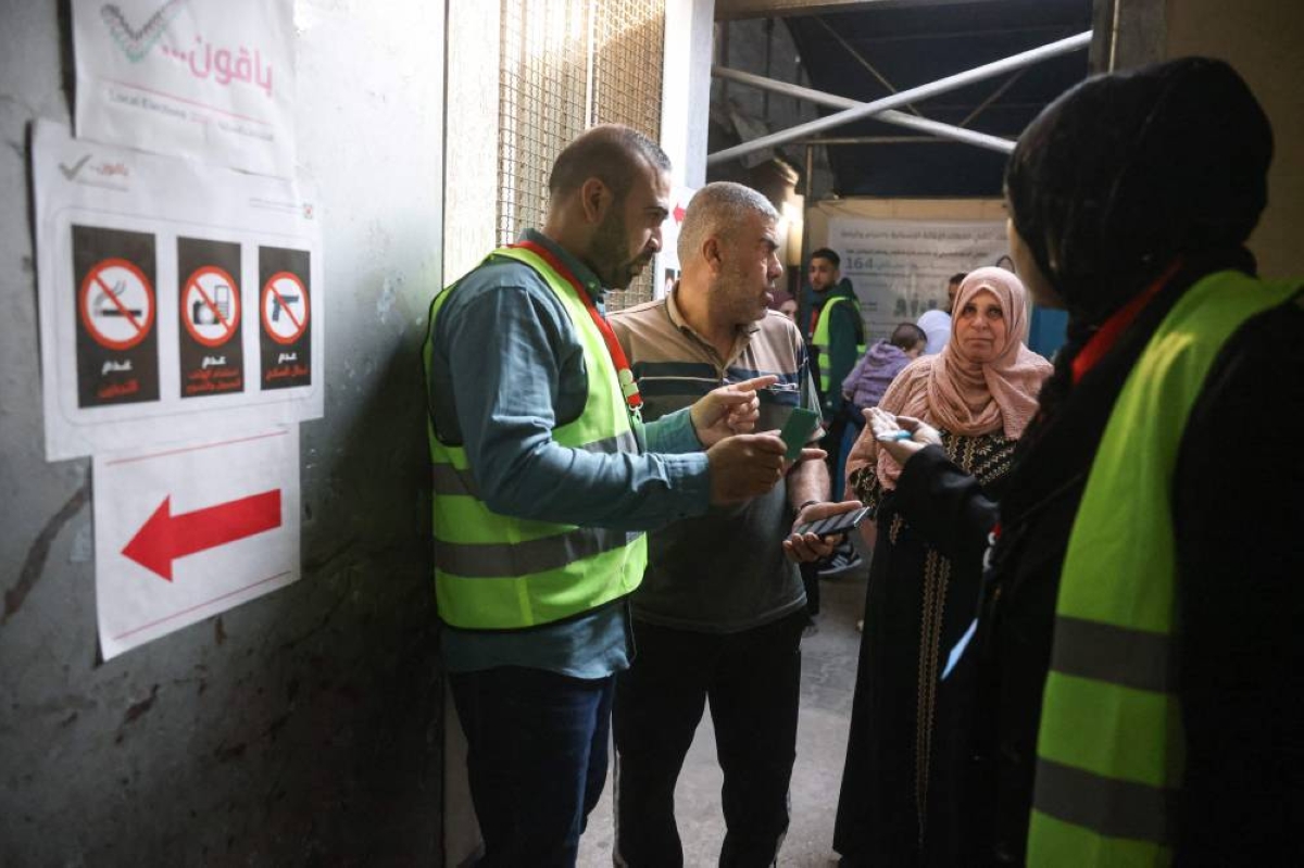 Voters arrive to cast their ballots at a polling station during municipal elections in Deir el-Balah, in the central Gaza Strip. – AFP