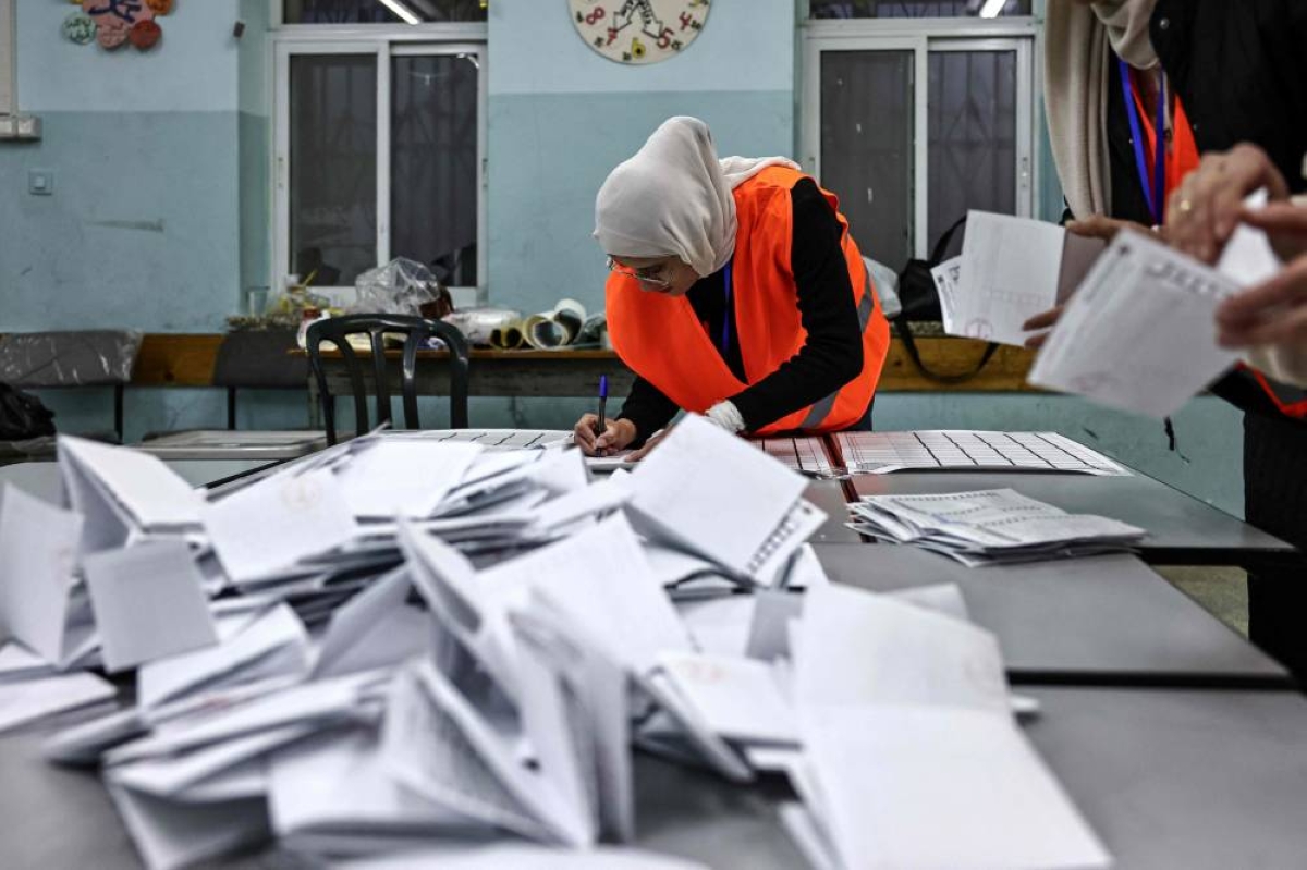 Electoral workers begin counting votes after the close of polling stations in the Israeli-occupied West Bank city of Al-Bireh. – AFP