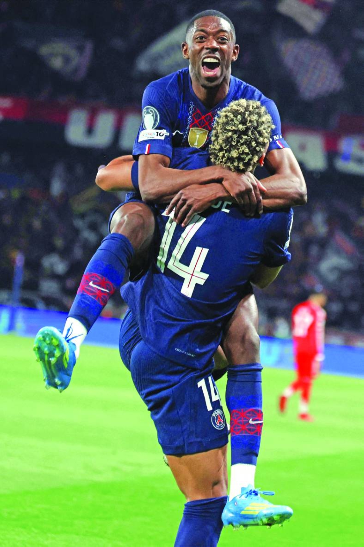 Paris Saint-Germain’s Ousmane Dembele celebrates with teammate Desire Doue after scoring his team’s fifth goal during the Champions League semi-final first leg match against Bayern Munich at the Parc des Princes in Paris Tuesday. (AFP)