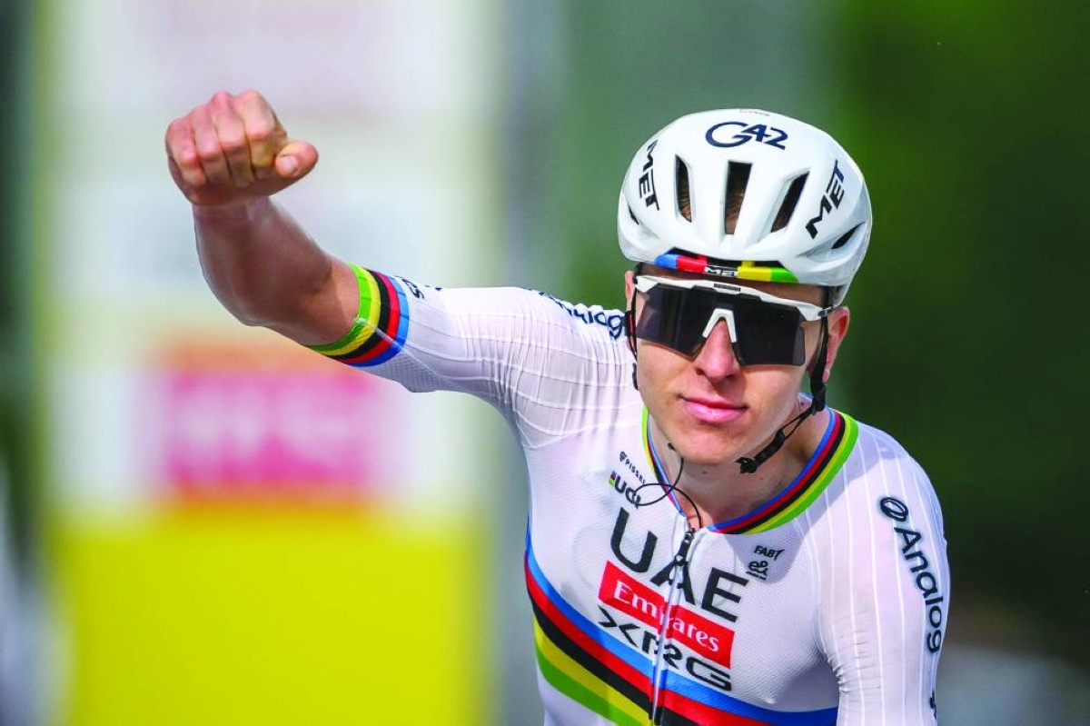 UAE Team Emirates-XRG’s Slovenian rider Tadej Pogacar celebrates as he crosses the finish line to win the first stage of the Tour of Romandie UCI cycling World tour, a 171.2 km loop from Martigny-Ville to Martigny-Ville, in Martigny, Wednesday. (AFP)